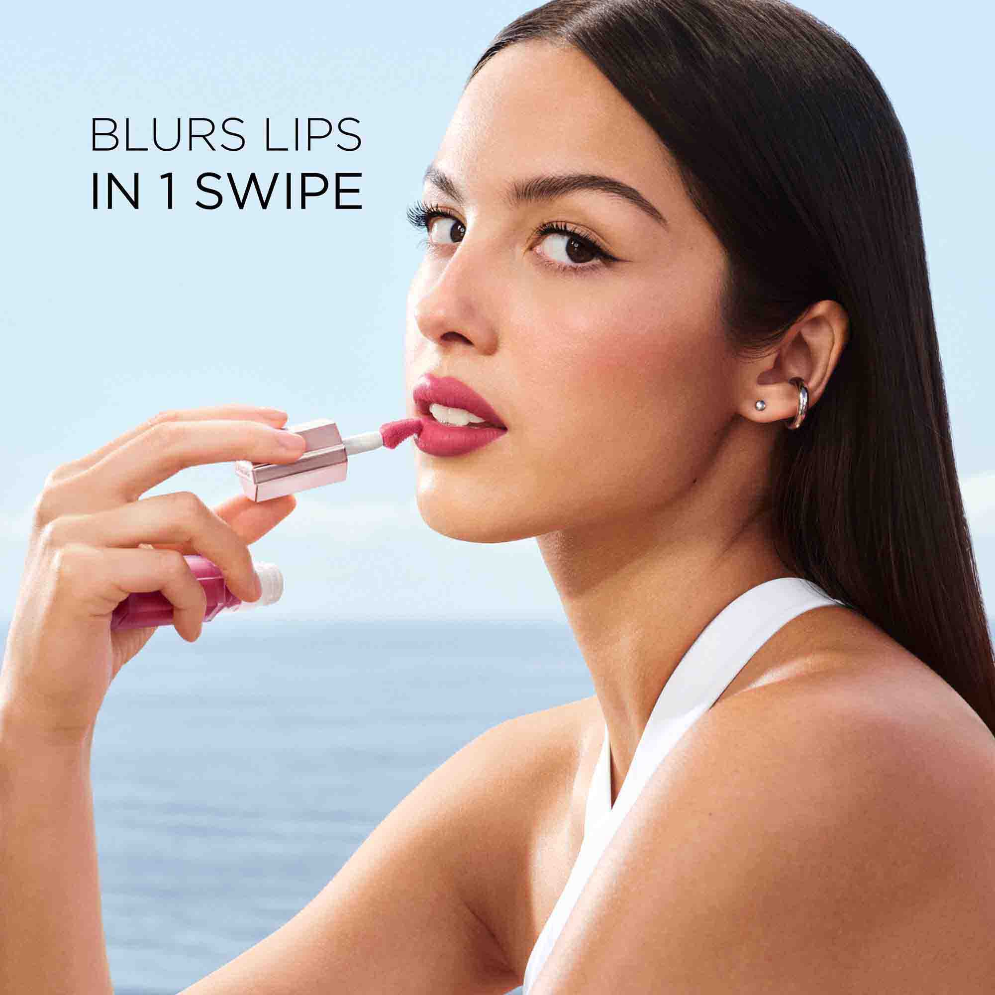 Olivia Rodrigo applying the lipstick