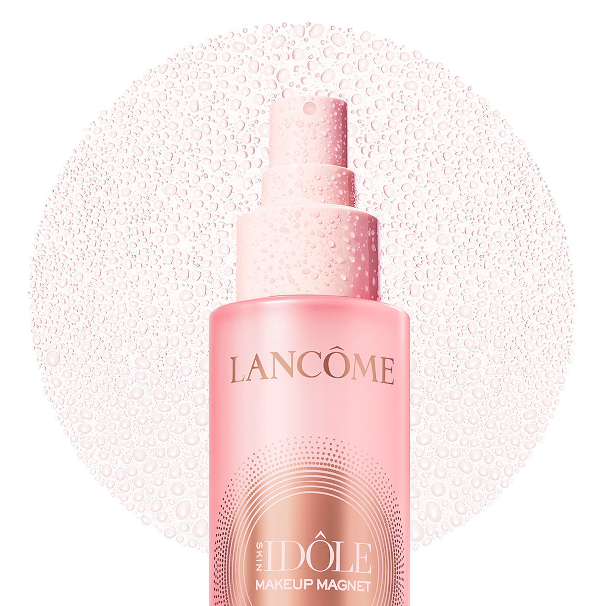 Top of pink bottle showing a fine circular mist spray.