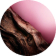 A dark, textured, and glossy wood-like element with reddish undertones cuts diagonally across a soft pink background.