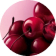 A pile of glossy, dark red to black cherries fills the bottom and right of the frame, set against a soft pink background.
